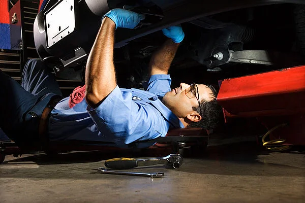 Auto mechanic fixing vehicle